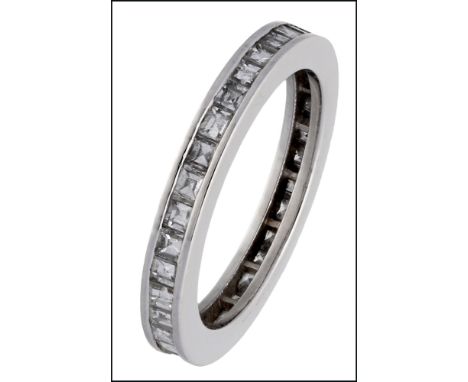 A diamond eternity ring, the polished band channel set with calibré-cut diamonds, mounted in white precious metal, ring size 