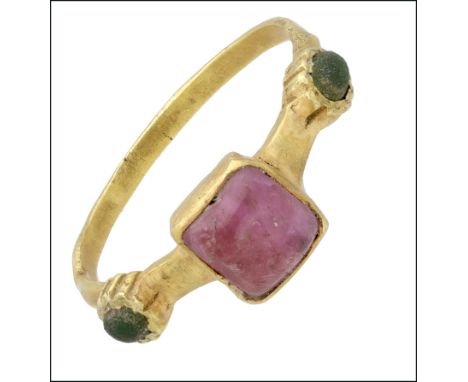 A late 13th/early 14th century gold, ruby and emerald ring, the hoop of D-shaped cross section, centred with a square bezel i