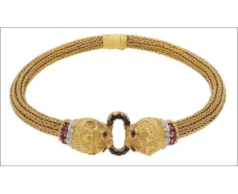 A choker necklace by Lalaounis, of flexible chevron weave design, centred with opposing lion heads, mounted with ruby and dia