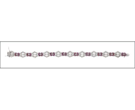 A ruby and diamond bracelet, of openwork foliate design, set throughout with circular-cut rubies, brilliant and single-cut di