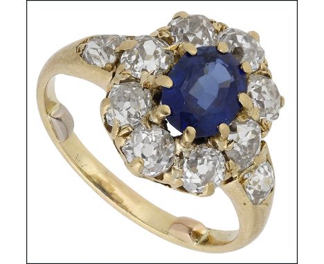 A sapphire and diamond cluster ring, circa 1900, the oval-cut sapphire within a surround of old brilliant-cut diamonds, mount