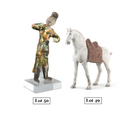 A SLIP DECORATED TERRACOTTA MODEL OF A HORSEChina, Tang DynastyThe horse naturalistically depicted standing four squares, on 