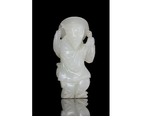 A JADE CARVING OF A FISHERMANChina,  Qing Dynasty, 19th centuryOffered at auction together with a matching wooden stand.H (st