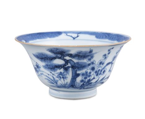 A ‘THREE FRIENDS OF WINTER’ BLUE AND WHITE PORCELAIN BOWLChina, Qing Dynasty, Kangxi periodResting on a ring foot, with an ev