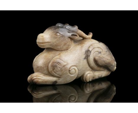 A LARGE CHICKEN BONE JADE CARVING OF A RECUMBENT DEERChina, Possibly Ming DynastyCarved as a recumbent deer or stag with curv