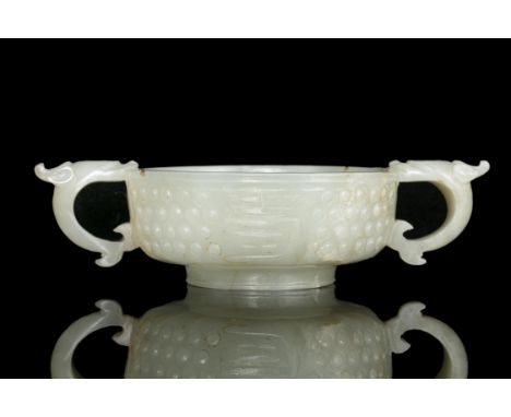 A JADE ‘RICE-GRAIN’ PATTERN AND ‘FU SHOU’ TWO-HANDLED CUP China, Ming Dynasty, 16th-17th century The cup is flanked on the si