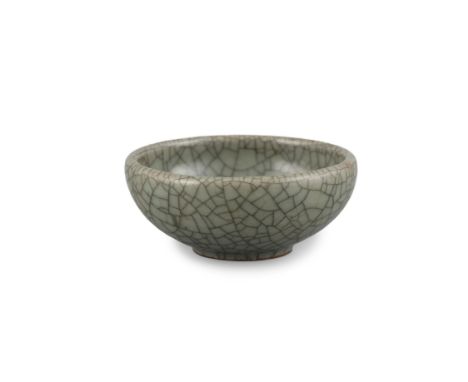 A SMALL GUAN TYPE SHALLOW CIRCULAR WINE CUPChina, Qing Dynasty, Presumably 18th centuryThe small circular cup resting on a sh