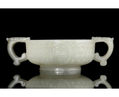 A JADE ‘RICE-GRAIN’ PATTERN AND ‘FU SHOU’ TWO-HANDLED CUP China, Ming Dynasty, 16th-17th century The cup is flanked on the si