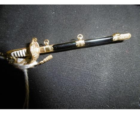 AN 18CT AND ENAMEL BROOCH IN FORM OF A SWORD