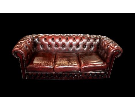 An Ox Blood Leather Chesterfield Sofa. With button back and arms. Measures approx 185 cms wide, 85 cms deep and 70 cms high. 