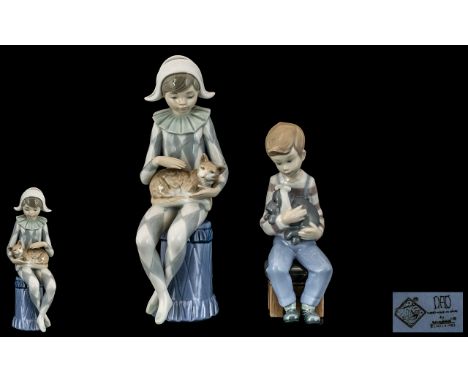 Nao by Lladro Pair of Hand Painted Porcelain Figures. Comprises 1/ Young Boy Harlequin Holding a Small Kittern. Height 9 Inch