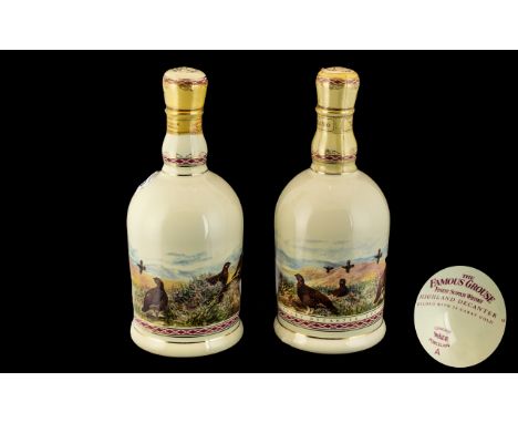 Two Famous Grouse Whisky Porcelain Collectible Bottles.  Two bottles of Famous Grouse housed within a ceramic 'Highland' deca