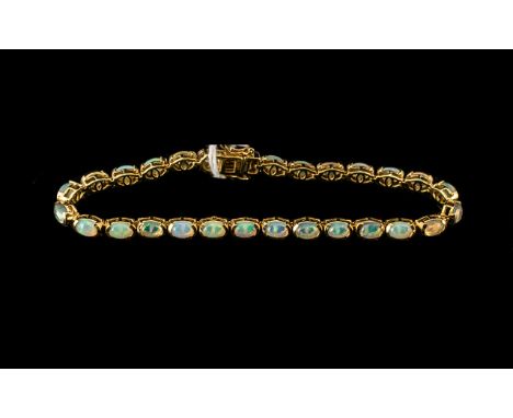 Natural Opal Tennis Bracelet, a wonderful array of colours showing in a single row of oval cut, cabochon opals, totalling ove