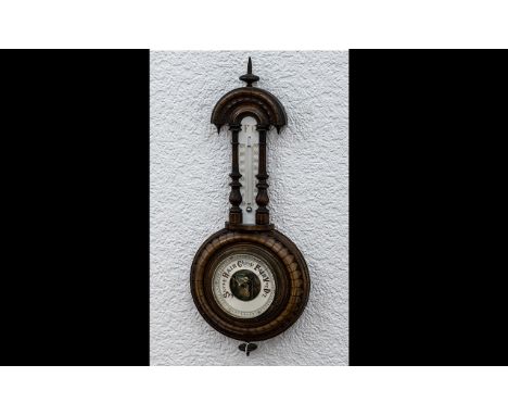 Small Carved Walnut Wall Barometer and thermometer, with a carved surround and column decoration.  20'' high.