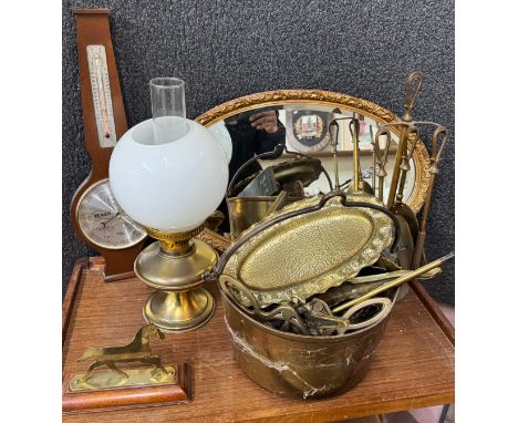 A collection of brass and metalware to include oil lamp, assorted items including clocks, mirror, table lighters and slide vi