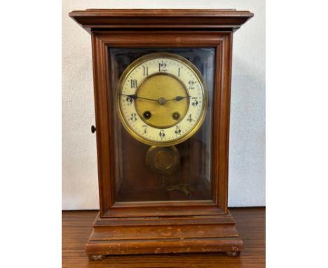 An early 20th Century French walnut and glass three sided mantle clock 