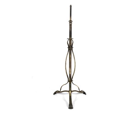 An Art Nouveau brushed steel standard lamp. The column decorated with three.decorative arched and scrolled stems terminating 