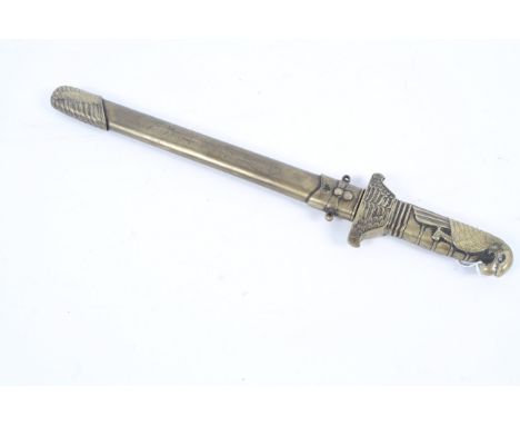 An unusual Oriental style brass knife. In brass scabbard, the handle in the form of an eagle, character marks to scabbard, ap