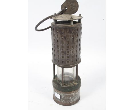 An early 20th century miner's lamp of Koehler type. With internal gauze chimney and pierced exterior, with a brass tag number