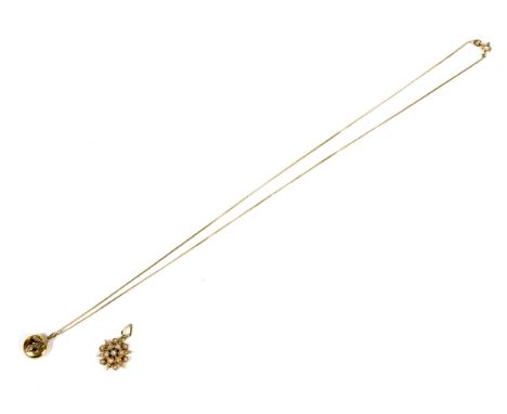 A yellow metal starburst pearl pendant and a gold pendant, on a gold necklace. The first weighing 2.2 grams, the second 15ct,
