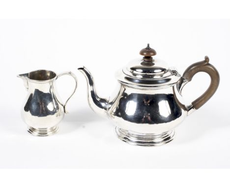 A silver teapot with horn handle and finial and matching cream jug. Both inscribed R &amp; AW 1901 - 1926, maker Bristol Gold