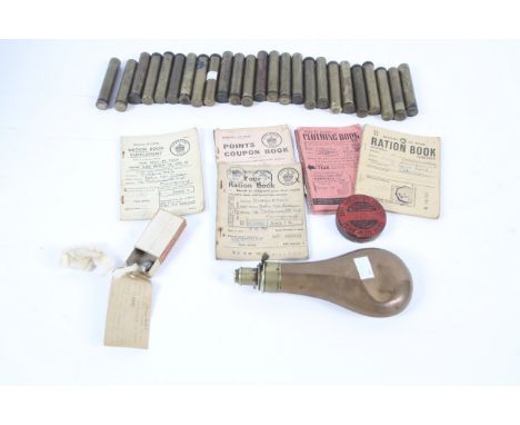 An assortment of military collectables. Comprising a quantity of brass canisters with metal caps opening to reveal spoons, ra