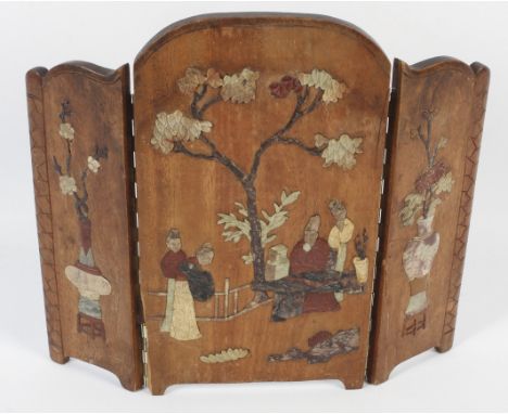 A Chinese tabletop two fold screen. Decorated with carved soapstone, the side panels decorated with vases and flowers on a st