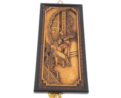 A 20th century Chinese fruitwood carved panel. Depicting a seated man receiving documents from a servant, 20cm x 45.5cm.