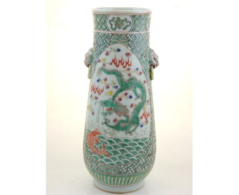 A Chinese cylindrical vase with twin dog of Fo handles, polychrome decorated with vignettes depicting mythical beasts above s