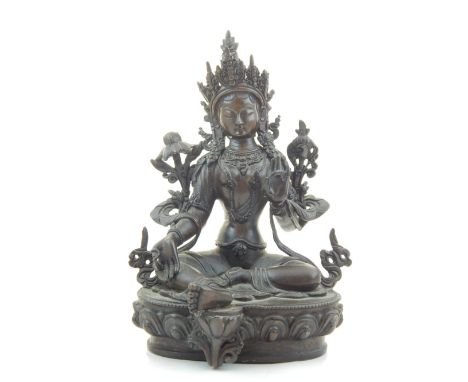 A bronze Buddhist figure, seated on a lotus blossom, H. 22cm.