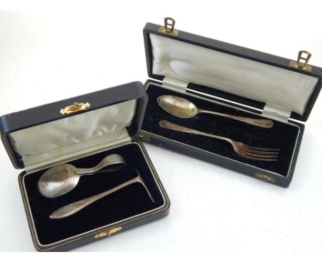 A George V silver christening fork and spoon together with a silver spoon and pusher set, both cased.