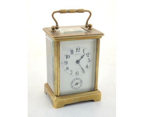An early 20th century French brass carriage clock, the white enamel dial with Roman numerals, subsidiary seconds dial below s