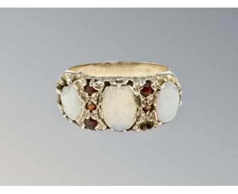 A 9ct gold opal and garnet ring, size Q CONDITION REPORT: 4.2g. One opal chipped. 