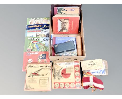 A box containing Bridge set, Danish cigarette card albums, playing cards. 