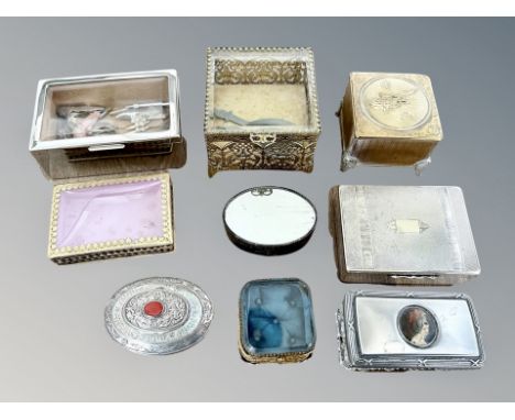 A group of trinket boxes including cast brass examples, mother of pearl and white metal cabochon-lidded oval box etc