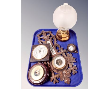 A tray containing carved oak barometer, two further barometers, oil lamp with etched glass shade and a pocket watch in leathe