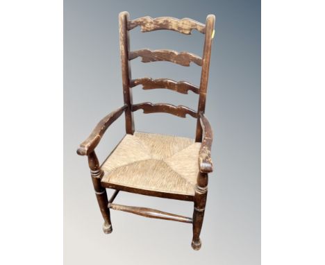A child's ladder backed armchair with rattan seat 
