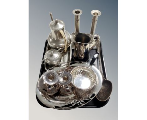 A tray of stainless steel and plated wares including pair of weighted candlesticks, serving ladle, tea set. 