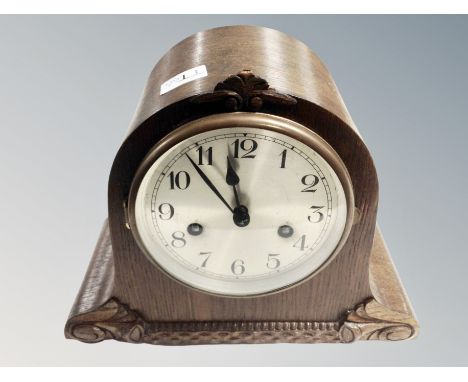 An oak cased mantel clock. 