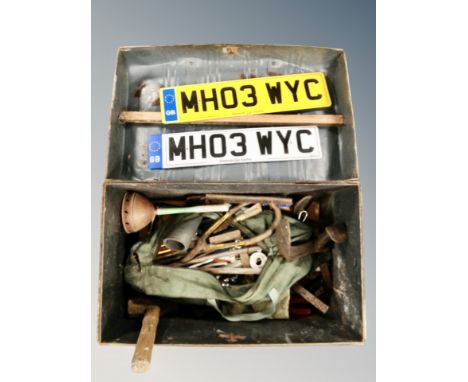 A tin trunk containing assorted hand tools, cobbler's last, registration plate and a further box containing lengths of rope. 