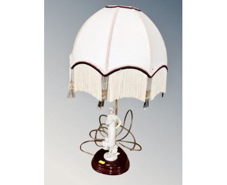 A Florence figural table lamp with tasseled shade 