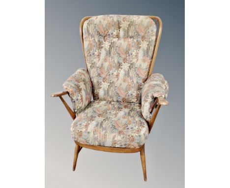 An Ercol elm and beech high backed armchair with cushions 