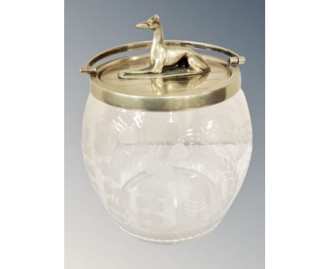 A Victorian glass biscuit barrel / ice bucket, extensively etched with wild plants and finial as a resting greyhound 
