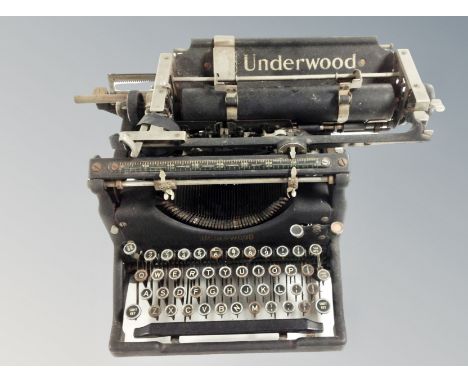 An Underwood typewriter and a child's Vulcan sewing machine. 