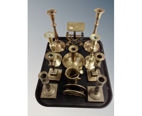 A tray of brass ware including several pairs of candlesticks, pestle and mortar chamber stick, set of scales. 