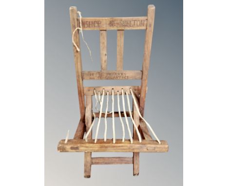 A child's folding armchair carved Bishop K Skelton to back rest 