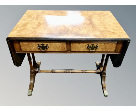 A Regency style flasp sided sofa coffee table on brass capped feet 