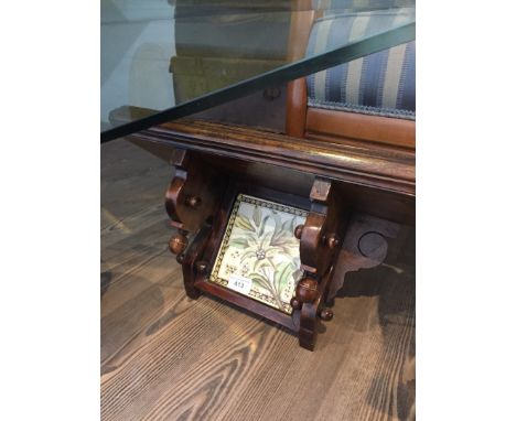 A wall shelf with Victorian tile insert. 