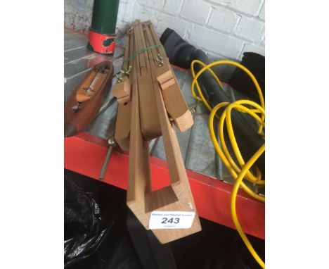 An artists easel and a wooden thermometer 