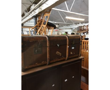 A vintage wooden bound travel trunk 